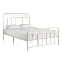 a white metal bed frame with two pillows