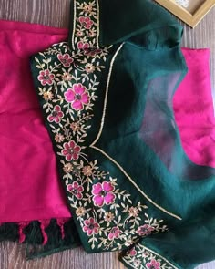 two pieces of green and pink sari with embroidered flowers on the border, one piece has