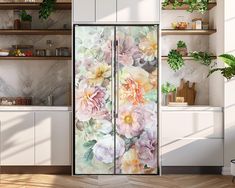 a kitchen with white cabinets and flowers painted on the glass doors, along with potted plants