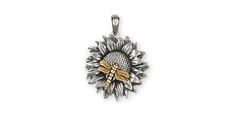 a silver and gold sunflower pendant on a white background