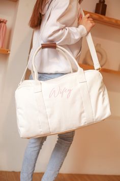 "Our new Weekender Bag is made from premium cotton canvas and is the perfect size for all of your wedding activities! * Monogramming is embroidery - get names, titles, monograms, initials! * Fully lined in cotton with small zipper pocket insert. * Interior Pocket to store essentials * Detachable shoulder strap DIMENSIONS : * Size : 20\" X 6.6\" X 11.8\" (L x W x H) Handle Height is 9.8\" Extended Strap Length is 55\" HOW TO ADD MONOGRAMMING DETAILS: 1. Choose your Bag color from the dropdown men Bride 2024, Bridal Shower Gifts For Bride, Bride Bag, Overnight Travel Bag, Bridal Shower Inspiration, Wedding Day Gifts, Bridesmaid Bags, Wedding Activities, Sac Week End