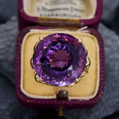 This stunning vintage ring features an organic design and is centered with a round modified brilliant cut amethyst, weighing 19.20 carats, in a four-prong setting. The ring measures 19.8mm at the top, rises 14.3mm above the finger, tapering to 3.8mm wide and 0.7mm thick at the base of the shank. It currently fits like a size 7.75. Luxury Solitaire Amethyst Ring, Timeless Round Amethyst Ring, Luxury Collectible Amethyst Ring, Formal Purple Amethyst Ring With Round Stone, Timeless Purple Amethyst Ring, Luxury Purple Amethyst Ring, Formal Amethyst Ring With Round Stone, Luxury Purple Amethyst Ring Round Cut, Luxury Purple Amethyst Round Cut Ring