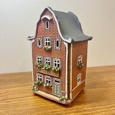 a small toy house sitting on top of a wooden table