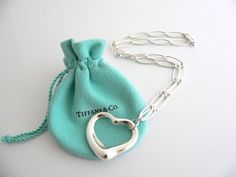 Overview: Offered for sale is a wonderful Tiffany & Co. Peretti Open Heart link necklace.  Definitely a Tiffany piece that you will get your money's value for.  It works perfectly with pretty much any attire your put on, AND adds a nice feminine touch to it.  The link chain for this specific piece is unique from most other necklaces - very smooth and substantial, yet the feel of the piece is still very delicate.  Hanging from the necklace is the quintessential Elsa Peretti Open Heart .  It i Pink Tiffany And Co Charms, Infinity Chain Necklace Tiffany Co, Tiffany N Co, Tiffany And Co Jewelry, Tiffany And Co Necklace, Pretty Jewelry Necklaces, Elsa Peretti, 925 Silver Bracelet, Tiffany And Co