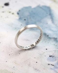 A modern reimagining of the classic Posey Ring, which were rings that were given as gifts with written messages on the inside of the band. This one is hand stamped with the positive affirmation ‘nothing is against me’ but you can personalise with your own wording inside the ring too. This 2mm wide silver ring is also perfect for stacking. Choose from black lettering for a bold message or to leave the letting uncoloured for a more subtle statement. Rings With Words, Posey Rings, Posey Ring, Virgo Star Sign, Wide Silver Ring, Stamped Rings, Affirmations Positives, Bridesmaid Bracelet, Positive Affirmation