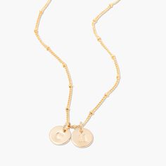 No matter where you are going, deck your neck with our classic Madeline two initial pendant. We love its delicate design and versatility. Rock it alone or as the base of an on-trend layered look. 3/8" gold filled, sterling silver or rose gold filled disc Hand stamped initial 16" brass satellite chain with 2" extender Lobster claw closure With customization this item is FINAL SALE NOTE - discs DO NOT slide on and off the chain. If you are looking to add or remove discs from the chain, the jump ri Dainty Initial Necklace With Charms, Dainty Rose Gold Initial Necklace With Charms, Dainty 14k Gold Filled Initial Necklace For Everyday, Dainty Adjustable Initial Necklace For Everyday, Adjustable Rose Gold Charm Necklace With Initial Pendant, Dainty Name Necklace With Delicate Adjustable Chain, Rose Gold Initial Pendant Necklace With Charms, Adjustable Rose Gold Initial Pendant Necklace, Adjustable Initial Pendant Name Necklace For Everyday