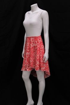 The Scarlet Garden Vintage Wrap Skirt is just in time for fall hues! The skirts are made of a wonderfully soft and flowy fabric, featuring white flowers on a bright red backdrop. Each skirt fastens around the waist with a slim, matching fabric tie. The asymmetrical wrap skirt hits above the knee in the front and brushes the upper calf in the back. Pair our vintage wrap skirts with leggings, stirrup tights, or a cropped sweater for a beautiful and cozy look for fall classes. The Scarlet Garden Vi Red Lined Asymmetrical Skirt, Red Asymmetrical Flowy Skirt, Red Casual Wrap Skirt For Summer, Casual Red Wrap Skirt For Summer, White Asymmetrical Skirt With Floral Print, White Asymmetrical Wrap Skirt For Spring, White Asymmetrical Floral Print Skirt, White Floral Print Asymmetrical Skirt, Chic Red Wrap Skirt For Summer