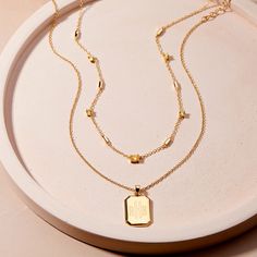 Add a personal touch to your style with the Willow Birthstone Layering Set! This unique set includes a custom birthstone necklace with an engraved pendant, perfect for layering or wearing on its own. This set is both stylish and meaningful. Available in 14k gold plated brass Willow Pendant: Size: 3/4" by 5/8"; Length: 18" cable chain with 2" extender Brenna Birthstone Necklace: Bar station size: 5mm, 3mm cubic zirconia round basket set stone, 6x4mm cubic zirconia oval basket set stone Length: 16 Minimalist Gold Birthstone Necklace With Charms, Gold Sterling Silver Birthstone Necklace Tarnish Resistant, Tarnish Resistant Gold Sterling Silver Birthstone Necklace, Gold Sterling Silver Tarnish-resistant Birthstone Necklace, Gold Pendant Birthstone Necklace, Dainty Gold Birthstone Necklace With Tarnish Resistance, Dainty Gold Birthstone Necklace Tarnish Resistant, Gold Dainty Birthstone Name Necklace, Gold Birthstone Necklace For Everyday And Mother's Day