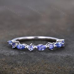 a white gold ring with blue sapphire stones