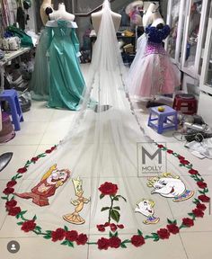 there are many dresses on display in the store and one is decorated with cartoon characters