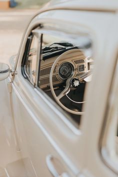 the interior of an old fashioned car with its dashboard and steering wheel visible through the window