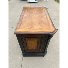 an old desk is sitting on the sidewalk