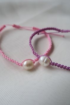 Handmade Pearl Bracelet | Friendship Bracelet, Adjustable Knotted Bracelet, Matching Bracelet, Couple Bracelet, Gift for Friendship These handmade bracelets are the perfect gift for friends, family, partners or even if its to treat yourself! Each bracelet is made with care and are easily adjustable. I hope you love them as much as I enjoy making them! The price displayed is for a singular bracelet or there is an option for the two at a discounted price. 𝐌𝐚𝐭𝐞𝐫𝐢𝐚𝐥𝐬: - 0.8mm Nylon Cord - F Adjustable Bangle Pearl Bracelet Gift, Adjustable Pearl Bangle Bracelet Gift, Handmade Adjustable Pearl Bracelet Gift, Adjustable Pearl Bracelet Gift, Handmade Adjustable Beaded Bracelets As Bridesmaid Gifts, Handmade Adjustable Beaded Bracelets For Bridesmaids, Handmade Adjustable Pearl Bracelet For Friendship, Pink Bracelet With Sliding Knot For Gift, Handmade Pearl Friendship Bracelet