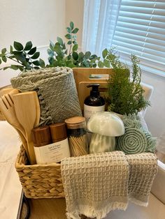 a basket filled with lots of items on top of a bed