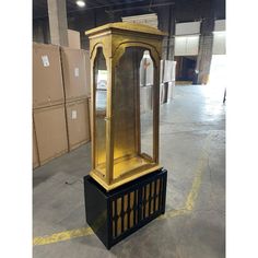 an old fashioned grandfather clock in a warehouse