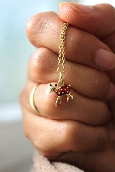 Introducing the delightful enamel 14k gold deer charm, perfect for adding a touch of sweetness to your jewelry collection! The luscious brownish red enamel color pops against the shiny gold, creating a stunning contrast that will catch the eye of anyone who sees it.  It's a versatile piece that can be worn on its own or paired with other charms to create a unique and personalized look.  This Reindeer charm is not only beautiful but also durable, thanks to its high-quality materials and handcrafted with love and attention to detail.  It's made with 14k gold, which is known for its durability and resistance to tarnishing, so you can wear it with confidence for years to come. Whether you're a deer lover or just appreciate the beauty of nature and Christmas inspired jewelry, this enamel 14k go Gold Deer, Gold Reindeer, Enamel Necklaces, Charm Gift, Gold Charm, Bead Charms, Reindeer, Deer, Charm Necklace