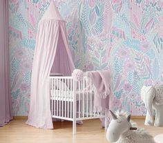 a baby's room decorated in pastel colors with pink and blue wallpaper