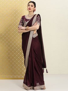 Burgundy and gold-toned sareeSolid solid saree with woven design borderHas sequinned detailThe saree comes with an unstitched blouse pieceThe blouse worn by the model might be for modelling purpose only. Check the image of the blouse piece to understand how the actual blouse piece looks like. Transitional Festive Pre-draped Saree With Embroidered Border, Traditional Pre-draped Saree With Embroidered Border In Chinon, Party Wear Pre-draped Chanderi Saree With Embroidered Border, Festive Dola Silk Pre-draped Saree With Embroidered Border, Bollywood Style Pre-draped Saree With Embroidered Border, Formal Festive Anarkali Pre-draped Saree, Formal Pre-draped Saree For Navratri, Designer Gold Pre-draped Saree With Embroidered Border, Elegant Gold Pre-draped Saree With Embroidered Border