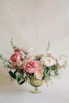 a vase filled with lots of pink and white flowers