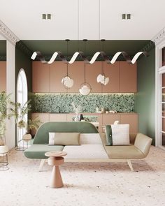 a living room filled with lots of furniture next to a wall covered in greenery