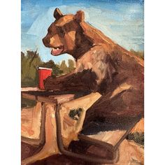 a painting of a bear sitting at a table with a drink in it's mouth