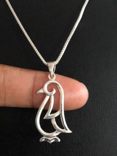 Penguin Necklace, Dainty Sterling Silver Penguin PendantNECKLACE FEATURES:Metal:  All components are made from solid .925 Sterling Silver Model is wearing 16" in length  solid .925 Sterling SilverChain Length available:  16", 18" or 20"Measurement:  Penguin Pendant Height: 32 mm (1.3 inches)Width: 13 mm (0.51 inch)Your Penguin Necklace will arrive in a gift box, beautifully wrapped and ready for giftingPlease send me a message if you have any questions before or after placing your order. ******* Penguin Pendant, Penguin Jewelry, Penguin Necklace, White Opal Earrings, October Birthstone Jewelry, Pentagram Pendant, Blue Opal Necklace, Silver Model, Fire Opal Necklace