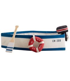 a life preserver and paddle on a blue striped belt with the name cm 209