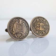 "A unique pair of cuff links that I made with original vintage 1944 Espana (Spain) Una Peseta coins. One cuff is the front of the coin while the other is the backside of the coin (some vintage wear). I lightly polished the raised highlights to bring out the writing and design. They are solid brass and I used antiqued gold tone cuff link backs encased in a two-part epoxy. 13/16\" (21mm) in diameter. They will come in a new gift box and this will be the exact pair you receive. If you need more tha Repurposed Vintage, Cuff Links, Vintage Wear, Antique Gold, Solid Brass, Cufflinks, Coin, Gold Tones, Spain