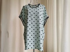 Vintage polka dots pattern summer top from the 1990's. Women's oversized summer top with a polka dot print in mint green and black. Has dolman sleeves and oversized boxy shape. Two small slits on the sides. Brand: Frankenwalder Material: 100% Polyester Size: Marked 38 DE, which is 8 US or M. Would fit even L. To be sure this item would fit you, please look at the measurements below. Approximate Measurements (taken when blouse lying flat, double armpit to armpit): Shoulder to Shoulder (from sleev Summer Polka Dot Crew Neck Top, Polka Dot Blouse For Summer Day Out, Polka Dot Blouse For A Summer Day Out, Polka Dot Blouse For Day Out In Summer, Summer Daywear Blouse With Crew Neck, Summer Crew Neck Blouse For Daywear, Spring Polka Dot Tops With Relaxed Fit, Summer Short Sleeve Polka Dot Top, Polka Dot Short Sleeve Spring Tops