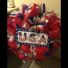 a red, white and blue wreath with the word usa on it