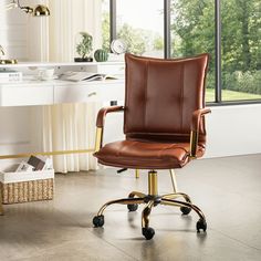 a brown leather office chair sitting in front of a window