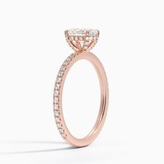 a rose gold engagement ring with diamonds on the side