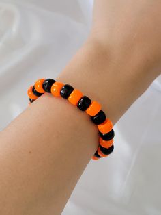 Introducing our handmade Halloween-Themed Beaded Bracelet - a festive accessory perfect for celebrating the spooky season! Crafted with vibrant orange and black beads, this bracelet captures the spirit of Halloween while staying stylish and fun. Whether you're dressing up for the holiday or simply want to add a seasonal touch to your everyday look, this bracelet is a great way to get into the Halloween vibe. As a small business owner, I handcraft each bracelet with care, ensuring every piece is unique and made to last. The bold colors make it perfect for stacking with other pieces or wearing on its own as a statement. Whether you're treating yourself or gifting it to a Halloween lover, this beaded bracelet is sure to bring some festive fun to your jewelry collection. Thank you for supporti Cheap Orange Halloween Bracelets, Casual Black Bracelets For Halloween, Adjustable Black Bracelets For Halloween, Handmade Bracelets For Halloween Party, Orange Beaded Bracelets For Halloween Gift, Halloween Party Beaded Bracelets, Black Stretch Bracelet With Round Beads For Halloween, Handmade Orange Beaded Bracelets For Party, Halloween Black Bracelets With Round Beads