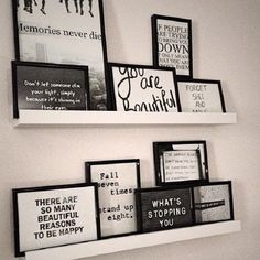 three black and white framed pictures hanging on the wall next to each other with words above them