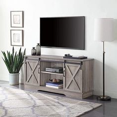 a flat screen tv sitting on top of a wooden entertainment center