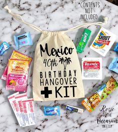 a birthday hangover kit is laid out on a marble counter with the contents labeled