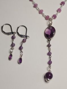 "Amethyst lariat necklace set.  Amethyst, pink jade rosery chain 20-22\" long, earrings are included." Amethyst Dangle Jewelry With Natural Stones, Amethyst Natural Stones Dangle Jewelry, Handmade Amethyst Long Drop Jewelry, Handmade Long Drop Amethyst Jewelry, Nickel-free Amethyst Long Drop Jewelry, Purple Long Drop Jewelry For Gift, Purple Long Drop Earrings For Gift, Amethyst Gemstone Beads Dangle Jewelry, Purple Gemstone Bead Pendant Jewelry