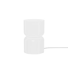 a white table lamp sitting on top of a white floor next to a black cord