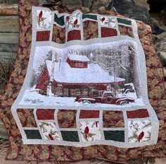 a quilted blanket with a red barn in the snow