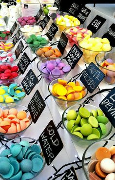 there are many different colored candies on the table