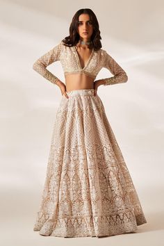 Peach attached cancan lehenga with intricate chikankari, sequin embroidery in floral pattern. Paired with embroidered full sleeve padded blouse and checkered embroidered dupatta.
Components: 3
Pattern: Embroidery
Type Of Work: Chikankari, sequin
Neckline: Plunge V neck
Sleeve Type: Full sleeves
Fabric: Organza
Color: Peach
Other Details: 
Attached inner lining
Lehenga:
Attached cancan
Floral pattern
Length: Approx. 43 - 47 inches
Weight: 3.5 kgs
Closure: Drawstring with zipper and hooks
Blouse: Traditional Lehenga Designs, Studio Iris, Cancan Lehenga, Chikankari Lehenga, Chikankari Embroidery, Latest Bridal Lehenga, Organza Embroidery, Organza Lehenga, Checkered Blouse