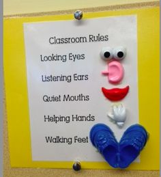 a classroom rules sign with an image of a smiling face and two hands holding a heart