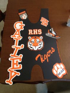 the back of a chair with an orange tiger on it's seat and some stickers that say, rhs tigers