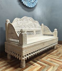 a white bed sitting on top of a wooden floor next to a blue and white wall