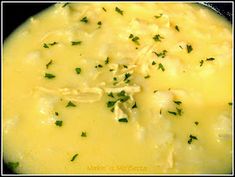 a close up of a bowl of food with broccoli and cheese on it