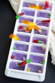 an ice tray filled with gummy bears on top of a table