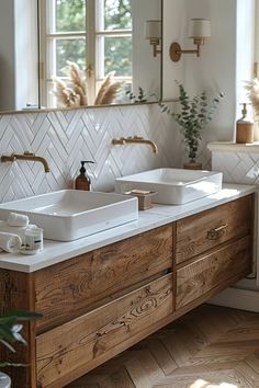 a bathroom with two sinks and mirrors in the middle of it, along with plants