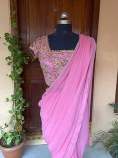 Saree with stitched blouse/ silk saree designer blouse / hand embroidery blouse USA / soft silk saree ready blouse / cocktail saree/ belt saree/ voggish / pink georgette saree/ heavy maggam blouse with saree  so bored of regular saree styles ? Then You really deserve to own this unique stylish saree look for your upcoming occassion that really makes you stand apart in crowd !!     You dont really need to stress your self in finding matching blouses for our sarees !! we pretty much carry our sarees with trendy stitched blouses or we will help you with our mix and match collection !! Here is a beautiful soft viscous georgette saree in onion pink color with simple pearl lace details paired with heavy hand embroidered designer blouse as shown !! Very light weight and stylish !! Blouse can be c Festive Pink Silk Pre-draped Saree, Festive Pink Pre-draped Saree With Mirror Work, Designer Pink Pre-draped Saree With Cutdana, Elegant Pink Chanderi Blouse Piece, Elegant Pink Chanderi Saree, Pink Silk Pre-draped Saree With Cutdana, Elegant Pink Art Silk Saree, Designer Pink Pre-draped Saree With Zari Work, Pink Anarkali Style Silk Pre-draped Saree