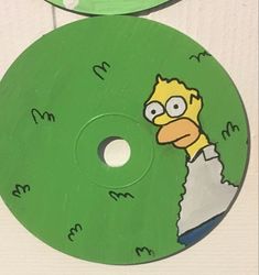 the simpsons character is depicted on this green disc for use as a cd or mp3 player