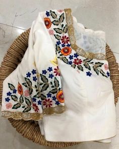 Blouses with colorful floral motifs are exceptionally popular nowadays. Resham work come in different colors suit an individuals style sense, this can help you to make a style statement of your own. Note: The chart mentions Body Measurements and not the garment dimensions. Fabric: Pure silk Neck: U neck at front and back Princess cut front. Bust pad: With or without cup insert. Half sleeve Front hook closure Cotton lining Color- Custom Colors possible. Size: All sizes possible This is made to or White Blouse Designs, Resham Work, Latest Model Blouse Designs, Cutwork Blouse Designs, Blouse Design Images, New Blouse Designs, Princess Jewelry, Ladies Blouse Designs, Maggam Work Blouses